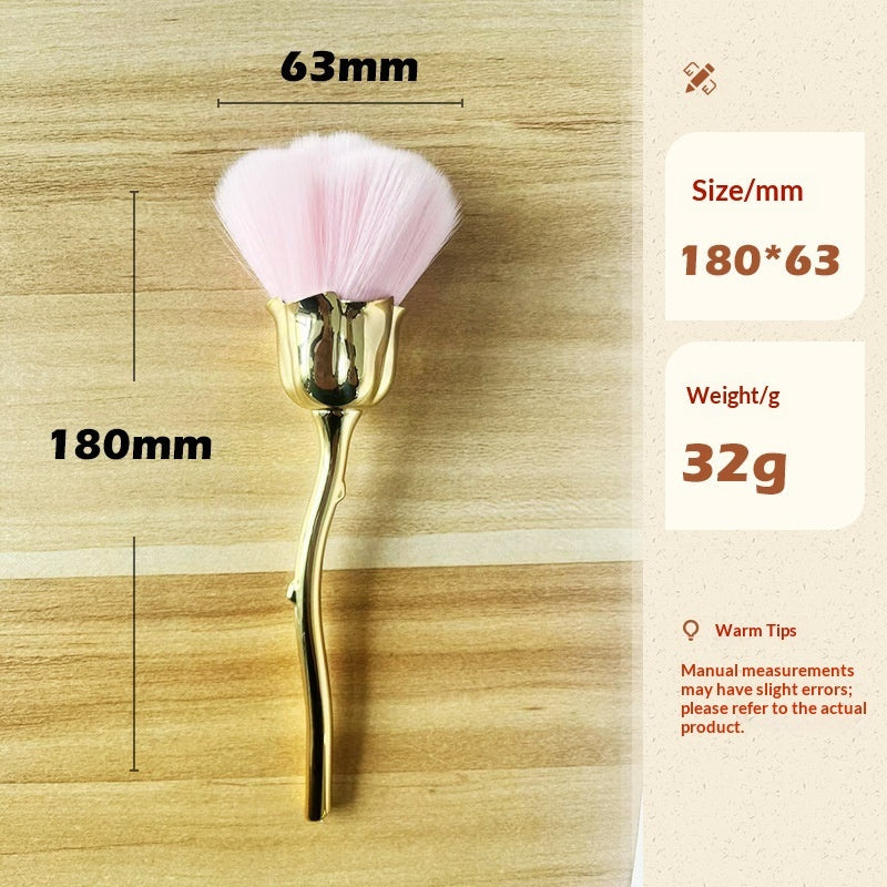 Makeup brush with soft pink bristles, metallic gold rose-shaped handle, and measurement graphics on wood background.