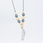 Baby teether necklace with alternating grey silicone and natural wood beads, finished with a grey silicone feather charm.