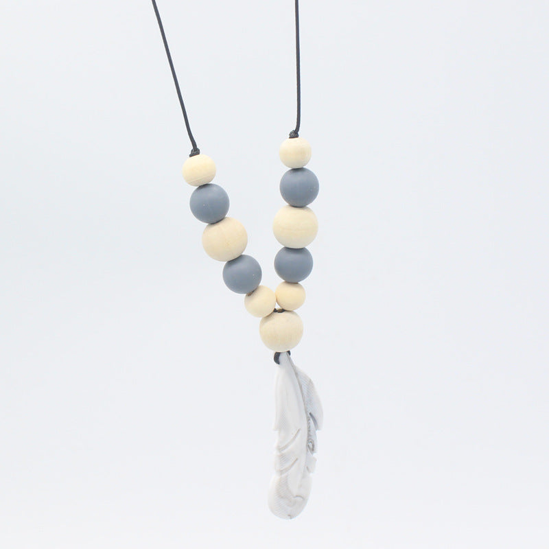 Baby teether necklace with alternating grey silicone and natural wood beads, finished with a grey silicone feather charm.