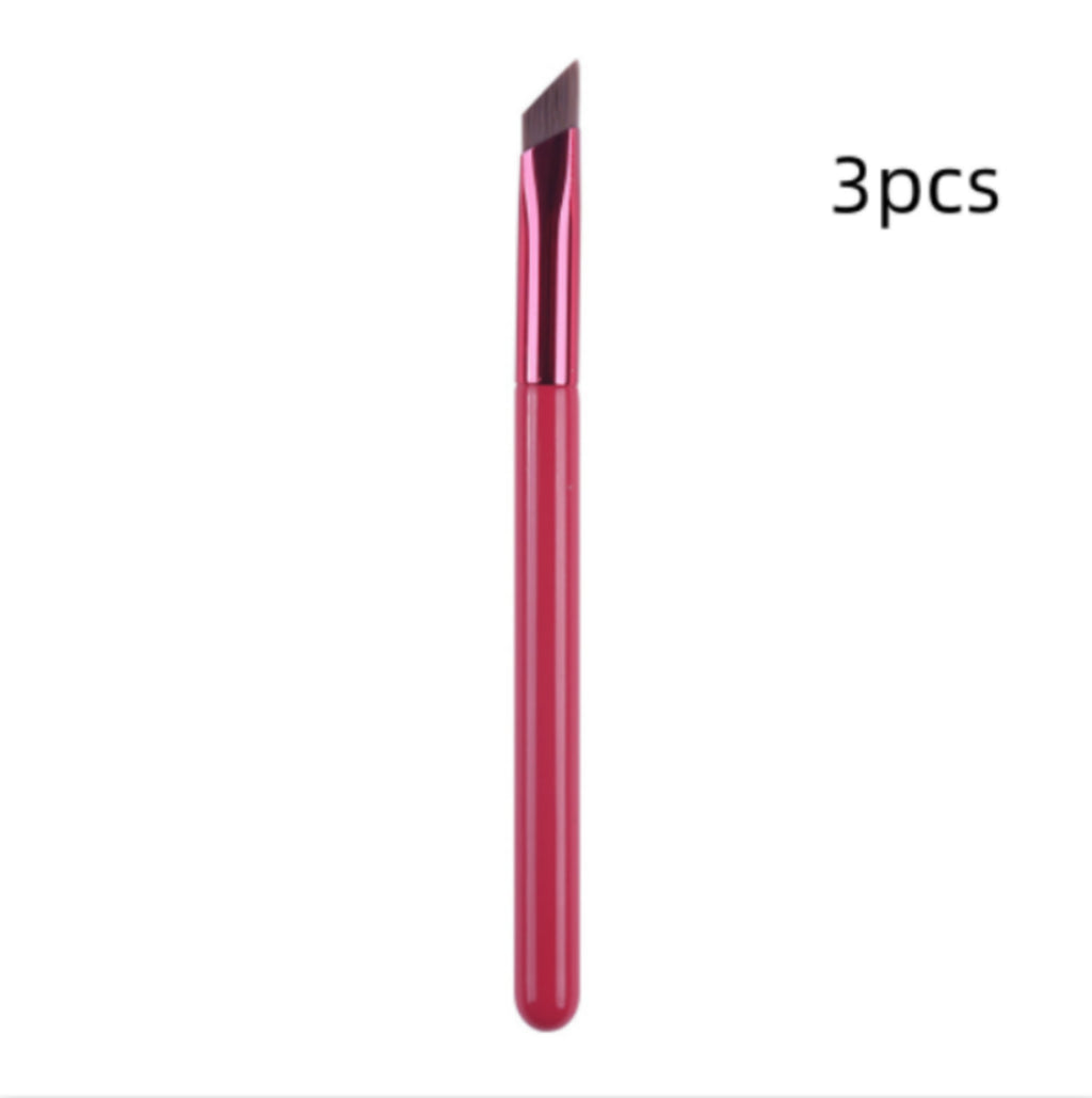 A 3-pack of pink angled eyebrow brushes with metallic ferrules and thin, precise bristles for detailed application.