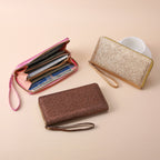 Three glittery, multi-functional zippered wristlet clutches in pink, gold, and brown, featuring card slots and storage.