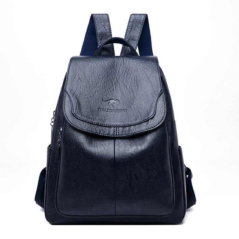 Dark navy blue soft leather backpack with a flap top, featuring a kangaroo logo and adjustable shoulder straps.