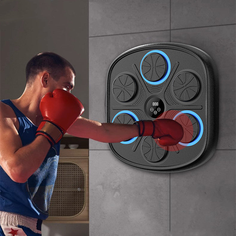 Person in red boxing gloves punching a wall-mounted black electronic target with blue LED light-up impact pads.