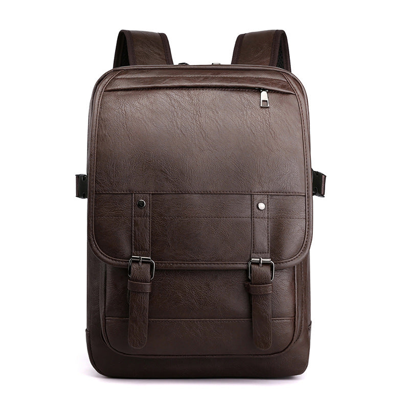A dark brown faux leather retro backpack with a top zip pocket, front flap, and buckle straps against a white background.