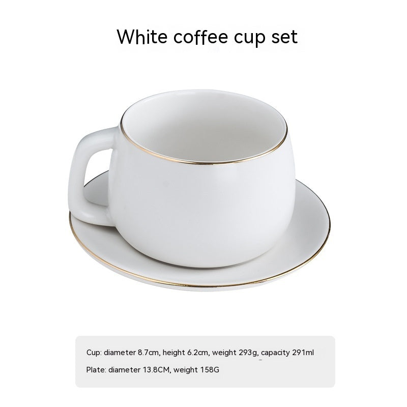Stylish white matte ceramic coffee cup and saucer set featuring minimalist design with elegant gold-rimmed edges.