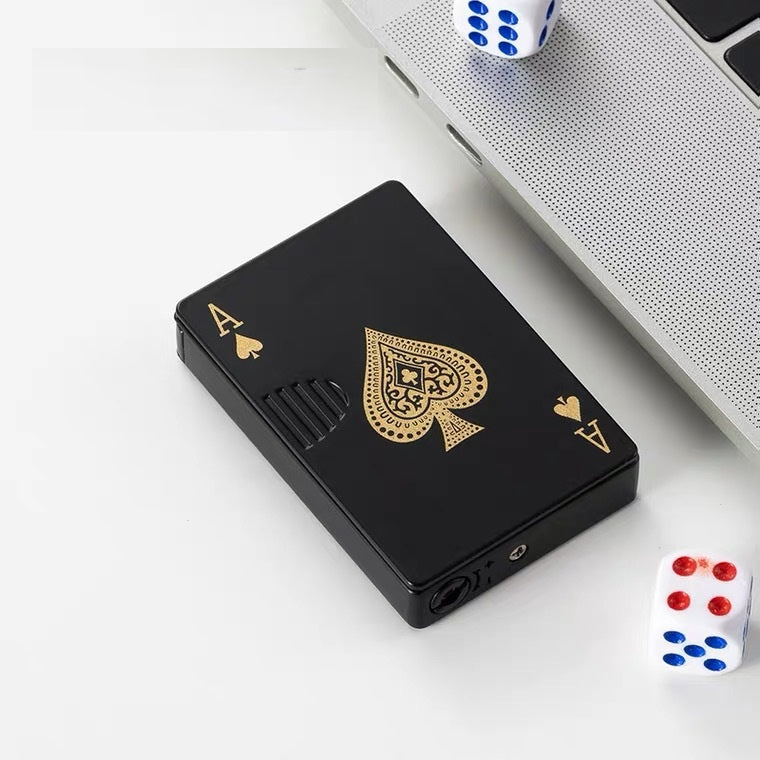 Black rectangular windproof lighter shaped like an Ace of Spades playing card with metallic gold detailing.