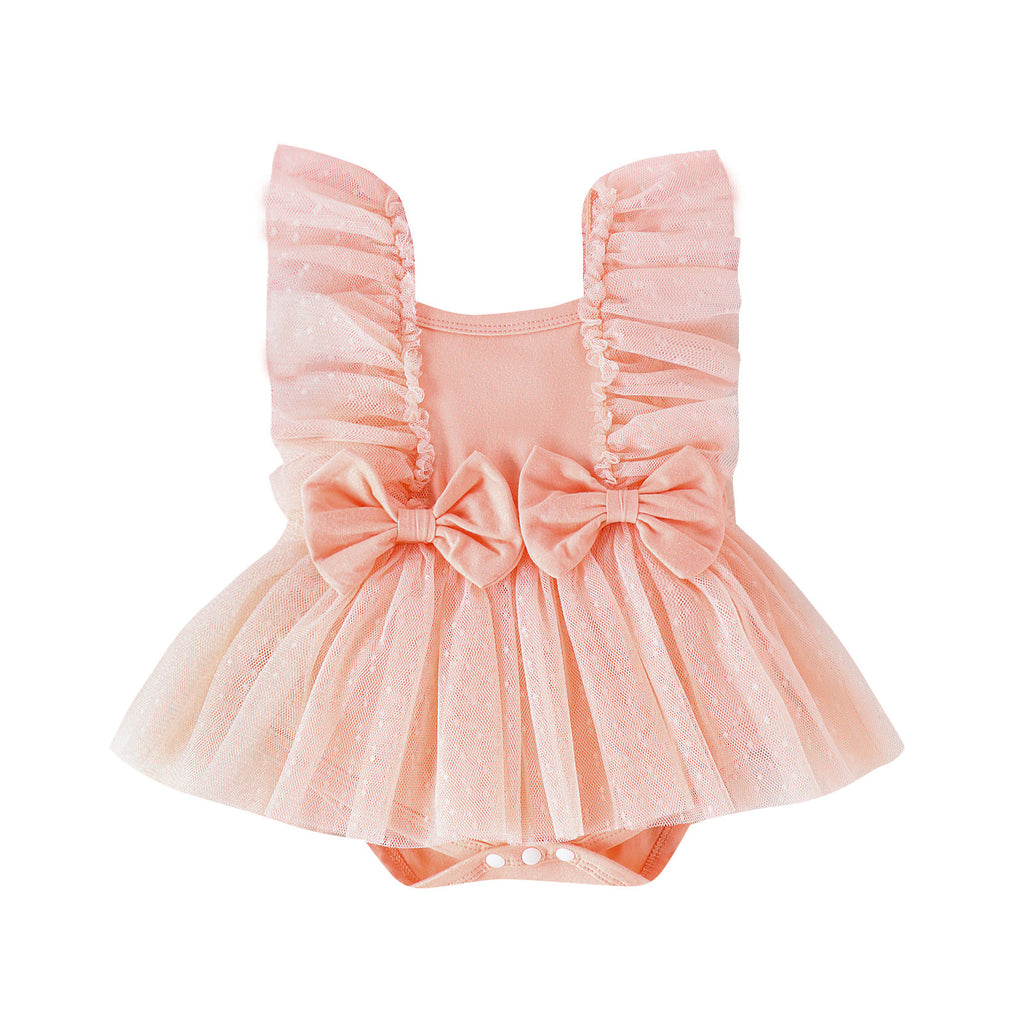 Peach-colored baby jumpsuit with frilly tulle trim, two front bows, and a snap-button bottom.