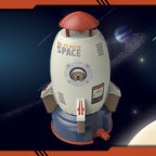 White and blue plastic rocket sprinkler toy with red top, space graphics, and bear astronaut window decal.