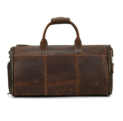 Vintage brown leather travel duffle bag with top carry handles, external side pockets, and durable zipper closures.