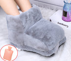 A person's feet inside a cozy, plush grey faux-fur electric warming bootie. Includes a pink water bag insert icon.
