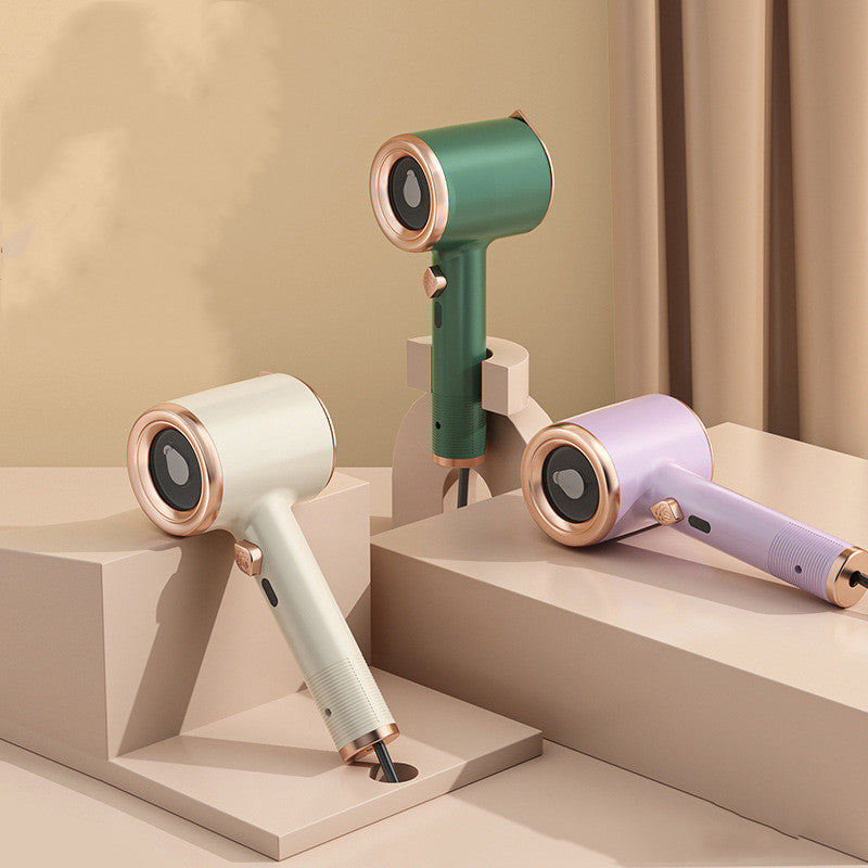 Three portable handheld garment steamers in green, white, and lilac with rose gold accents on tiered display pedestals.