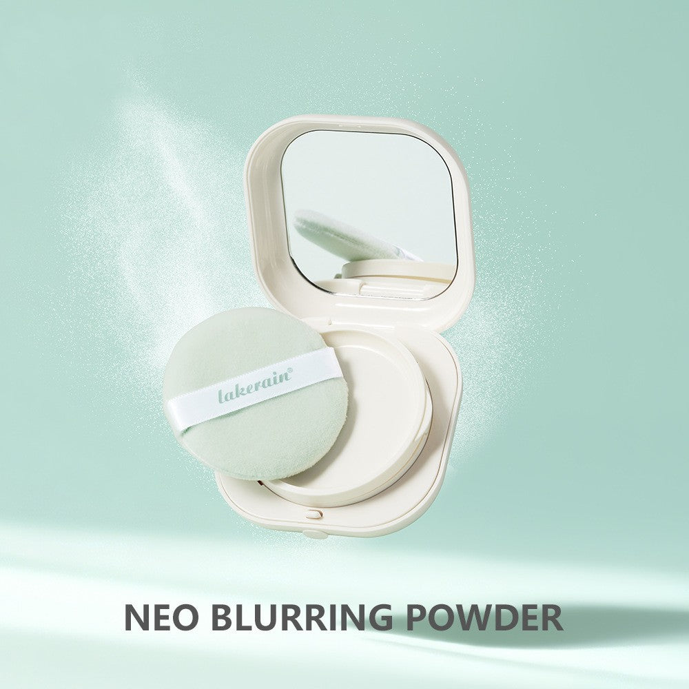 An open, cream-colored compact with a mirror and mint green powder puff, floating against a light green background.