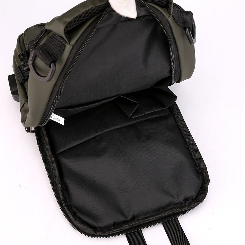 Open olive green multifunctional crossbody chest bag with black interior lining, multiple compartments, and D-rings.