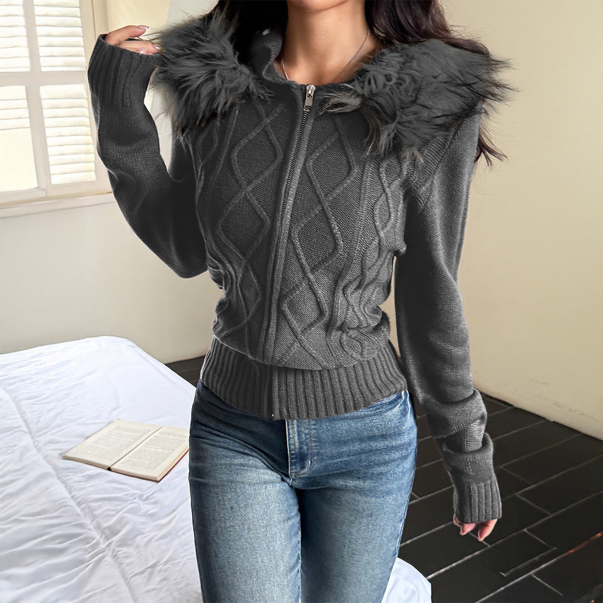Charcoal grey zip-up sweater coat with a cable-knit pattern, ribbed cuffs, and a faux fur trimmed hood.