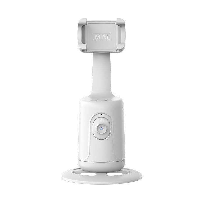 White plastic auto-tracking phone gimbal with a 360-degree rotating base and adjustable spring-loaded phone holder.