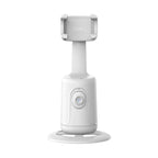 White plastic auto-tracking phone gimbal with a 360-degree rotating base and adjustable spring-loaded phone holder.