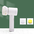 White electric household cleaning brush with a fuzzy head, plus interchangeable brush and yellow sponge attachments.