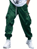 Green cargo joggers with drawstring waist, side flap pockets, and elastic cuffs. Streetwear style, smooth material.
