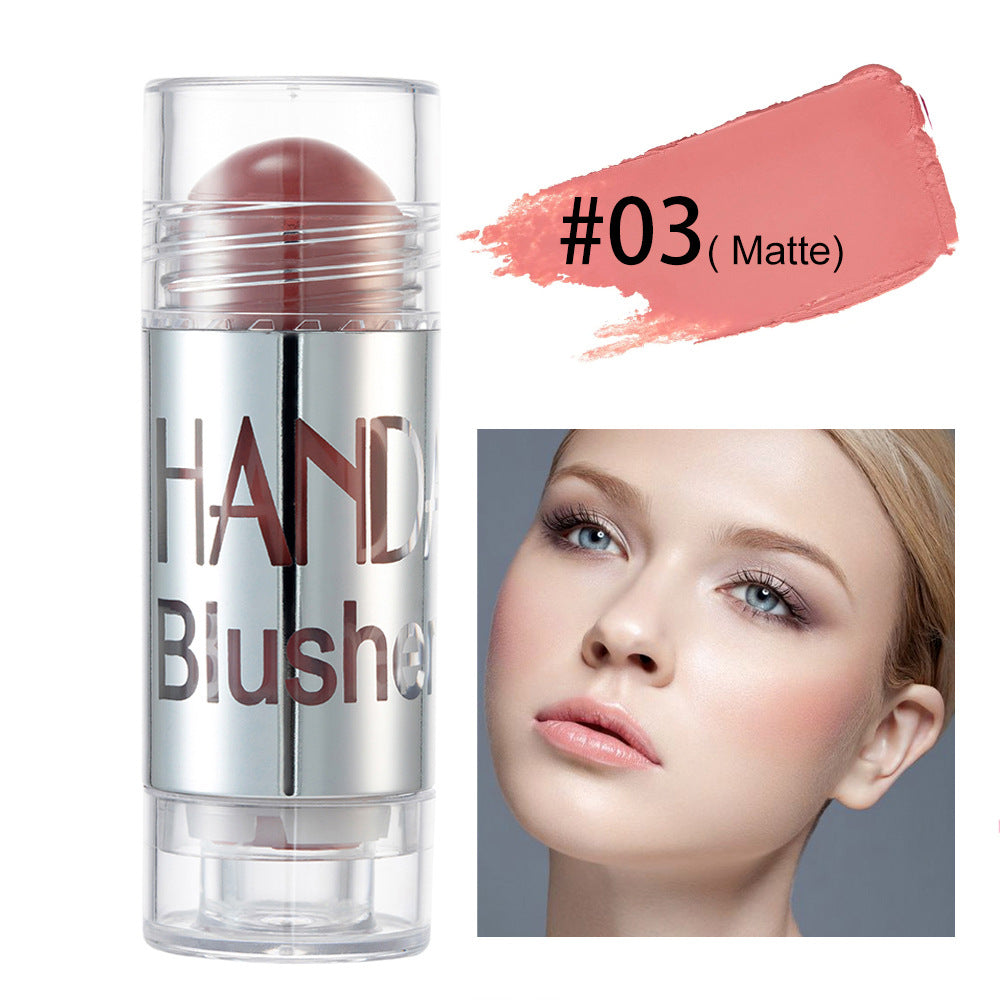 Digitaldistribution375 matte pink blush stick in a clear, silver-capped tube next to a model wearing the shade.