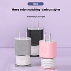 Silicone protective cases for Apple USB-C chargers in gray, black, and pink, featuring integrated cable organizers.