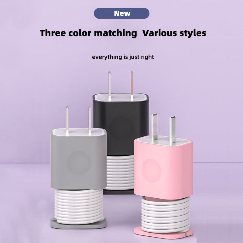 Silicone protective cases for Apple USB-C chargers in gray, black, and pink, featuring integrated cable organizers.