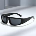 Glossy black hip-hop sports sunglasses with rectangular frames and dark, protective lenses on a neutral gray surface.