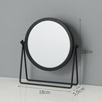 Black round tabletop makeup mirror on a metal stand with 18cm x 21cm x 5.5cm dimensions.