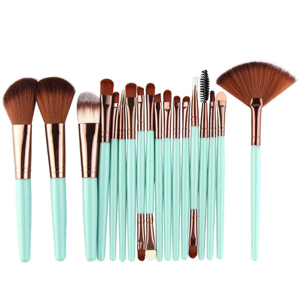 A set of makeup brushes with mint green handles, rose gold ferrules, and soft brown synthetic bristles.