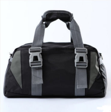 Black and grey fabric gym bag with two front buckles, top carry handles, and a sleek, sporty design.