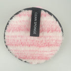 Round, pink and white striped fuzzy cleansing sponge with a black "CLEAN SPONGE" label on a light gray background.