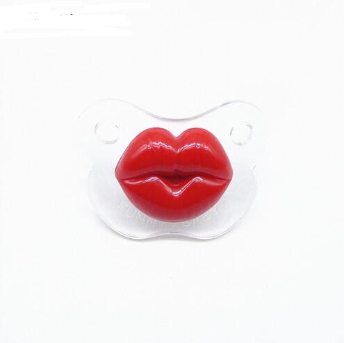 Clear plastic baby pacifier featuring bright red, shiny, oversized lips in the center on a white background.