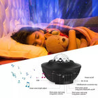 Black USB LED music player night light with a crystal dome, projecting colorful ocean waves over a sleeping child.