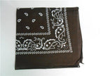 A dark brown square bandana featuring a classic white paisley and floral print with a patterned border.