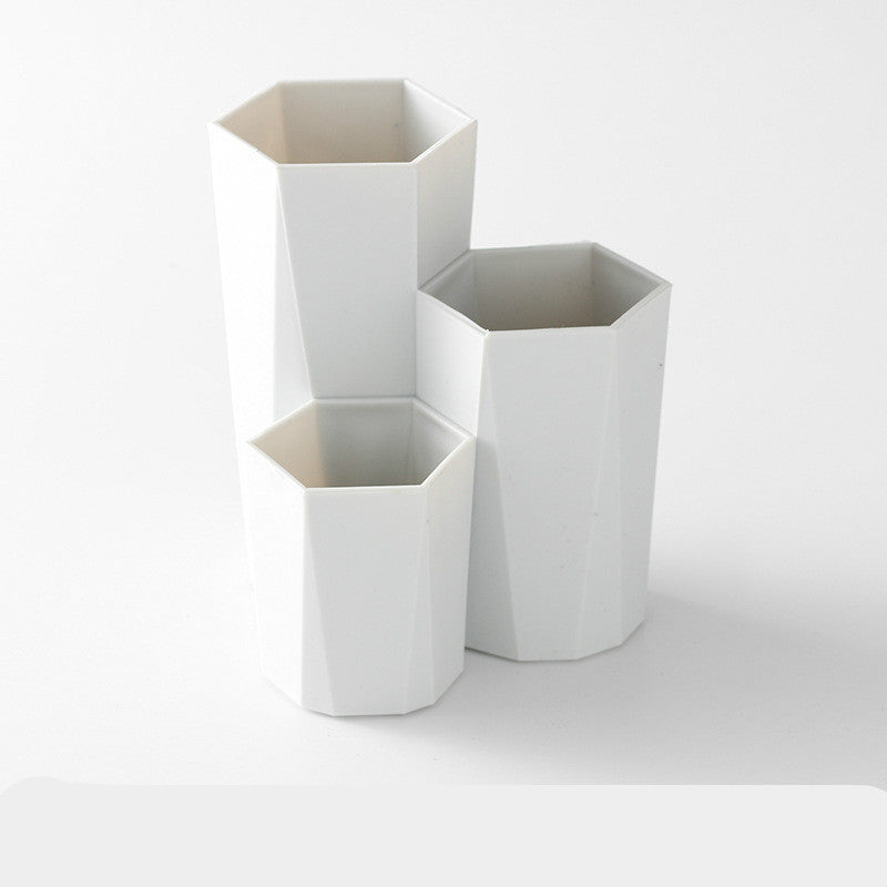 White, three-tiered hexagonal plastic makeup brush storage organizer.