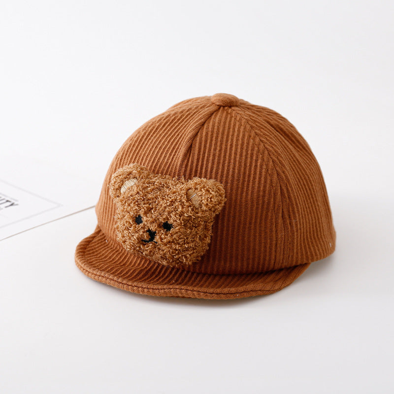 Brown ribbed baby baseball cap featuring a cute, fuzzy plush teddy bear face patch on the front.