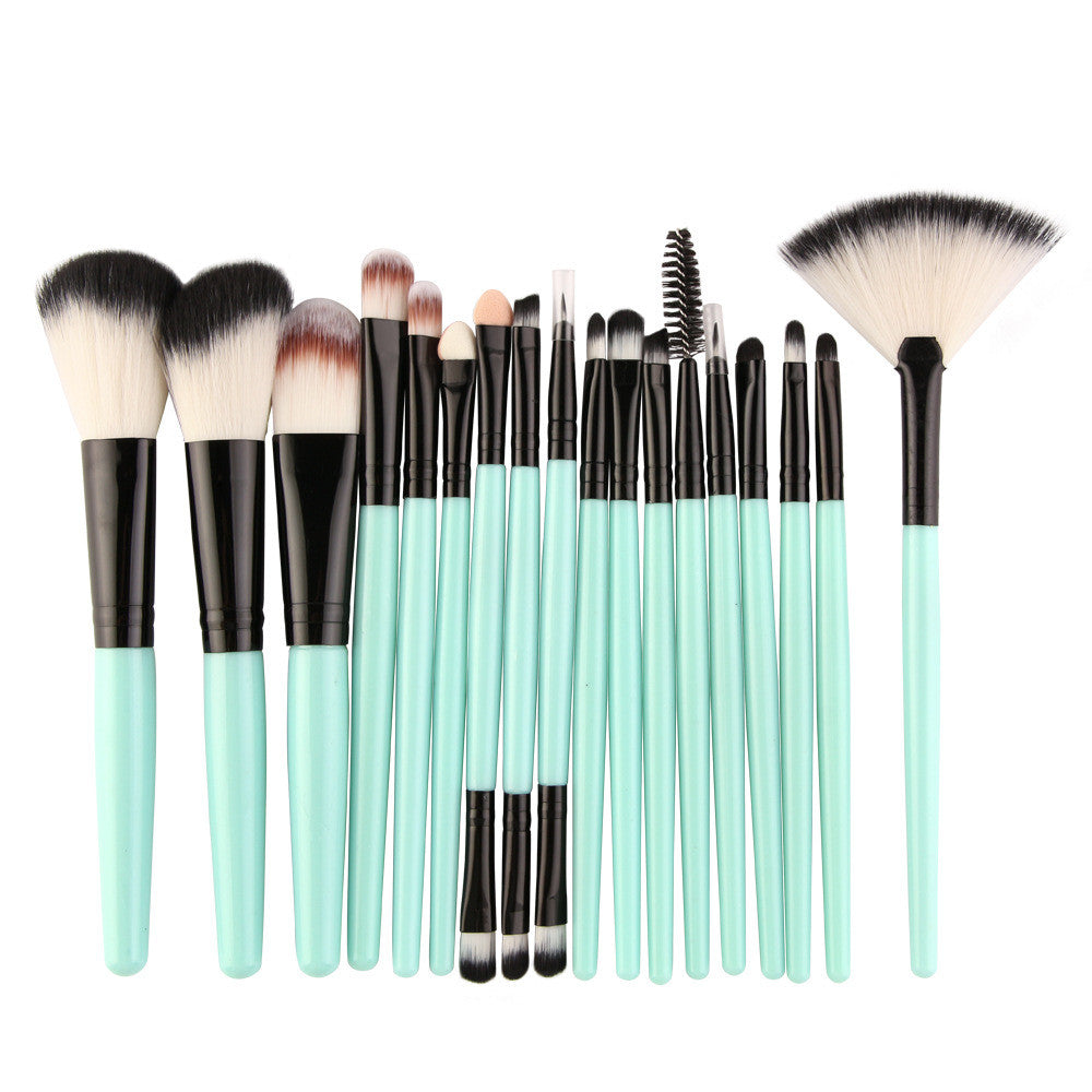 A 15-piece makeup brush set with mint green handles, black ferrules, and soft, multi-colored synthetic bristles.