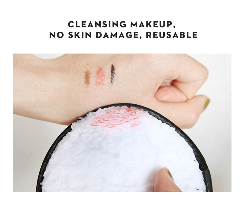 White, plush makeup cleansing puff removing lipstick and eyeliner from a hand. Reusable, gentle fabric.