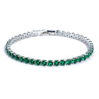 Silver-tone tennis bracelet featuring a single row of round, micro-inlaid emerald green zircon stones.