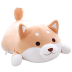 Soft, tan and white plush Shiba Inu dog toy with a chubby, cylindrical shape and cute, embroidered facial features.