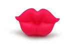 Bright pink, silicone novelty baby pacifier shaped like puckered, realistic human lips against a white background.