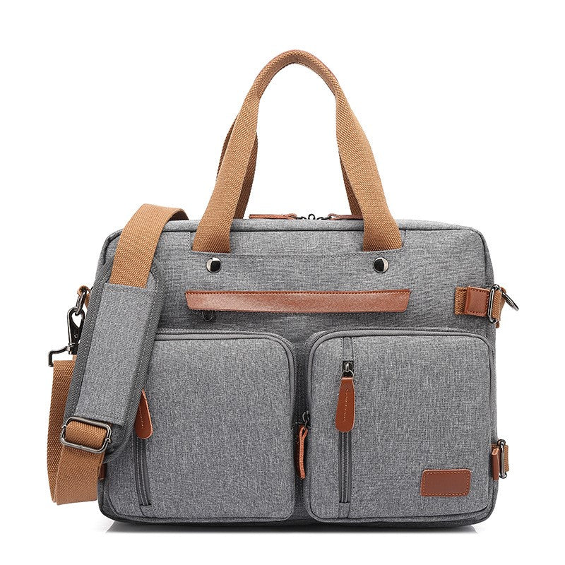 Gray multifunctional canvas bag with tan handles, shoulder strap, multiple zippered pockets, and faux leather accents.
