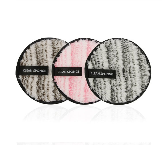 Three round, fuzzy, striped microfiber makeup remover pads in brown, pink, and grey with "CLEAN SPONGE" labels.