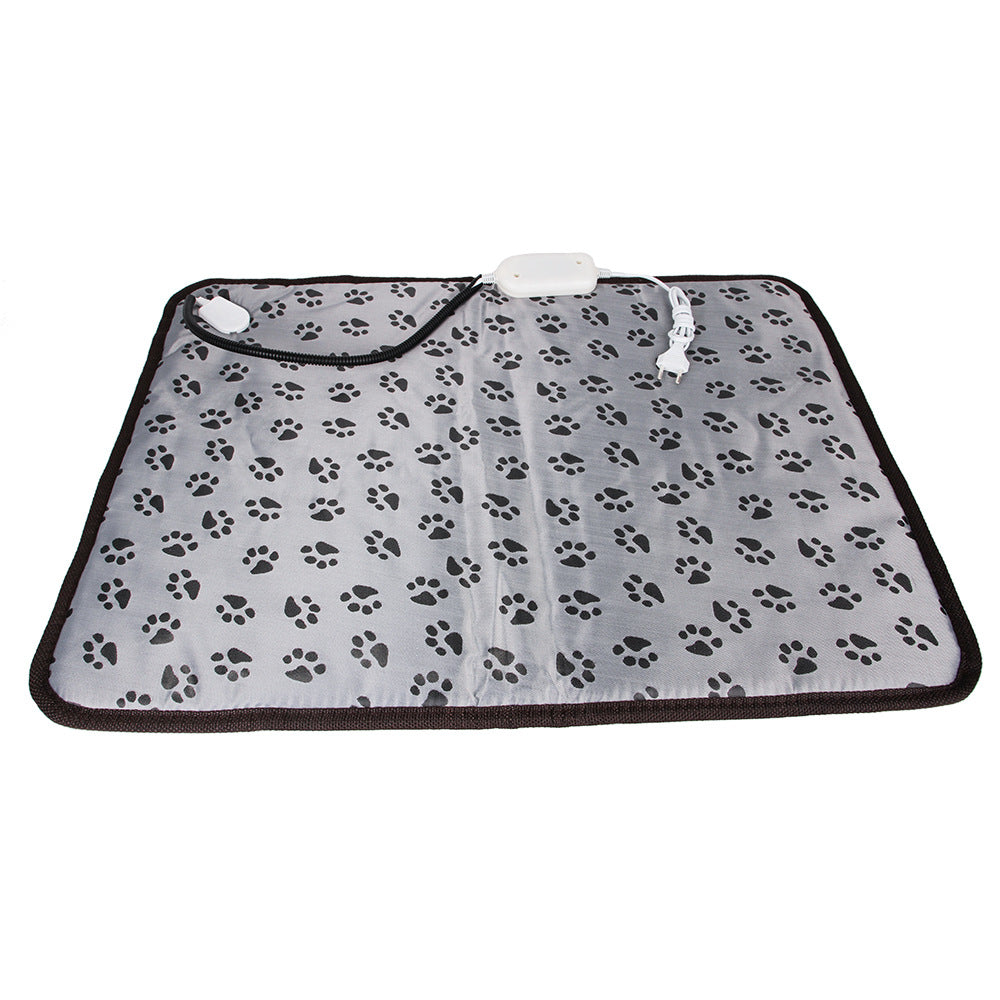 Grey rectangular pet heating pad with black paw prints, brown trim, and a chew-resistant cord with white plug.
