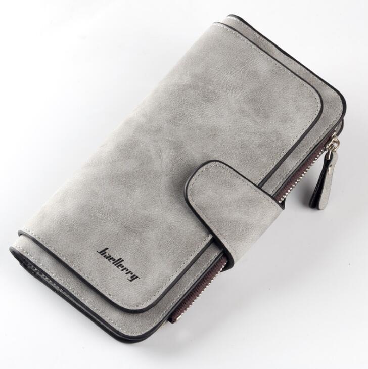 Gray Baellerry long wallet in matte, faux-suede finish with a snap-button flap, side zipper, and dark brown trim.