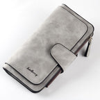 Gray Baellerry long wallet in matte, faux-suede finish with a snap-button flap, side zipper, and dark brown trim.