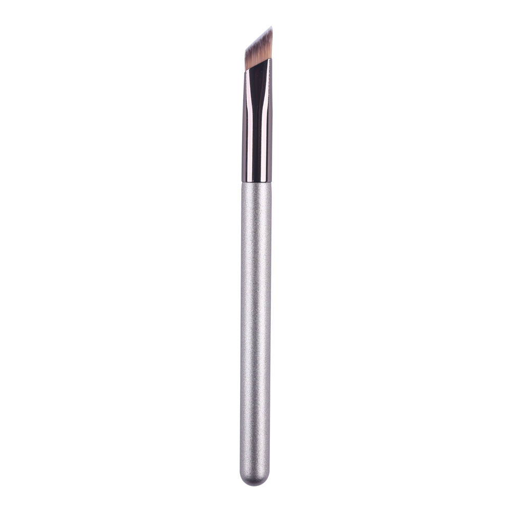 An angled brow makeup brush with a sleek silver handle and synthetic brown bristles, isolated on a white background.