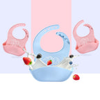 Pink and blue silicone baby bibs with elephant prints, adjustable neck straps, and crumb-catching food pockets.