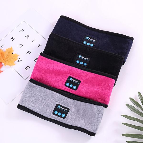 Four fleece Bluetooth headbands in blue, black, pink, and grey with built-in music control buttons on each.