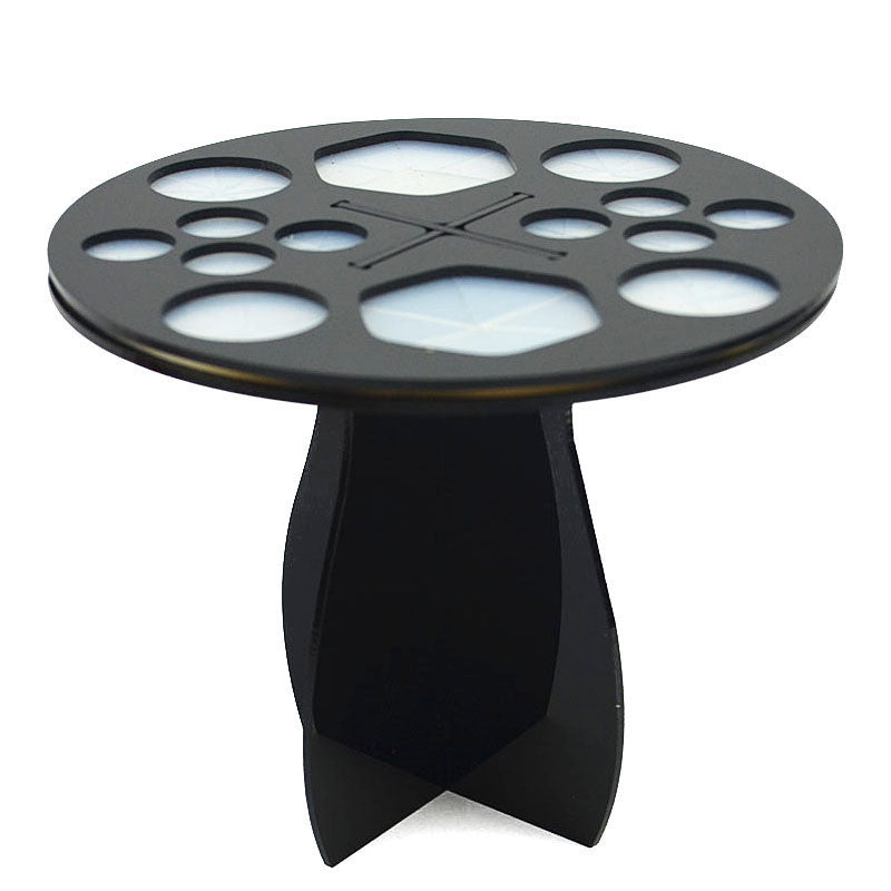 Black, 14-hole circular makeup brush drying rack with silicone inserts and a sturdy, intersecting stand base.