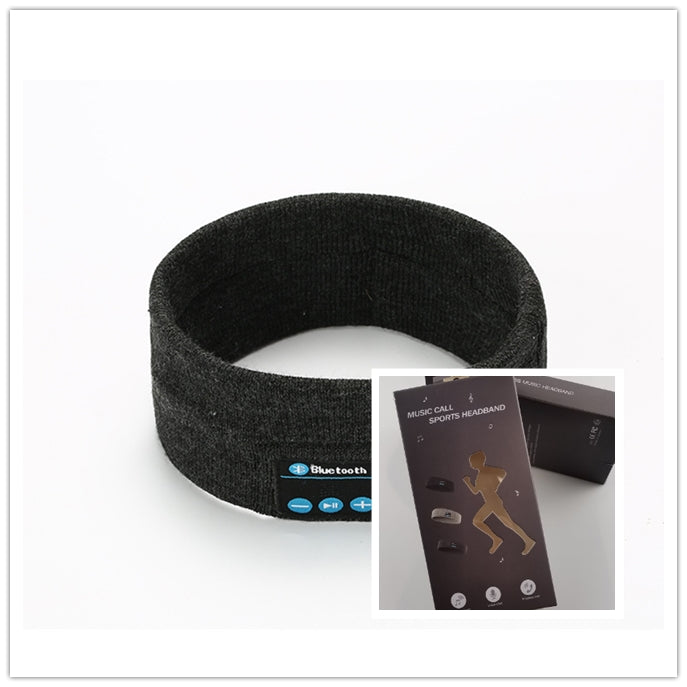 Dark gray fabric Bluetooth sports headband with integrated music controls, shown with its retail packaging box.